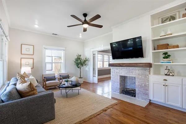 a living room with furniture a fireplace and a flat screen tv