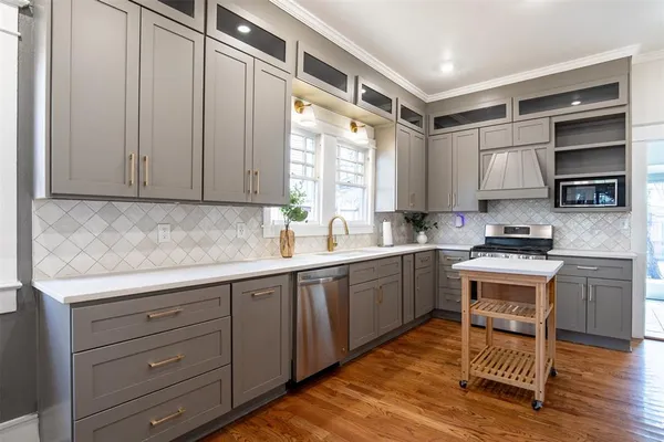 a kitchen with a sink window and cabinets
