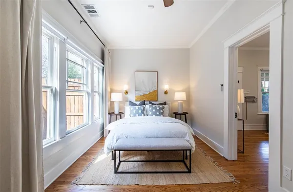 a bedroom with a bed and wooden floor