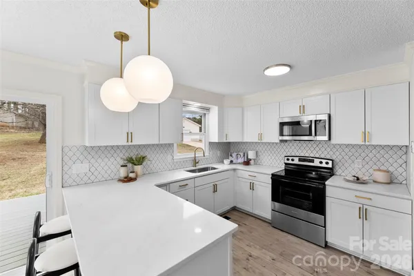 a kitchen with a sink cabinets and window