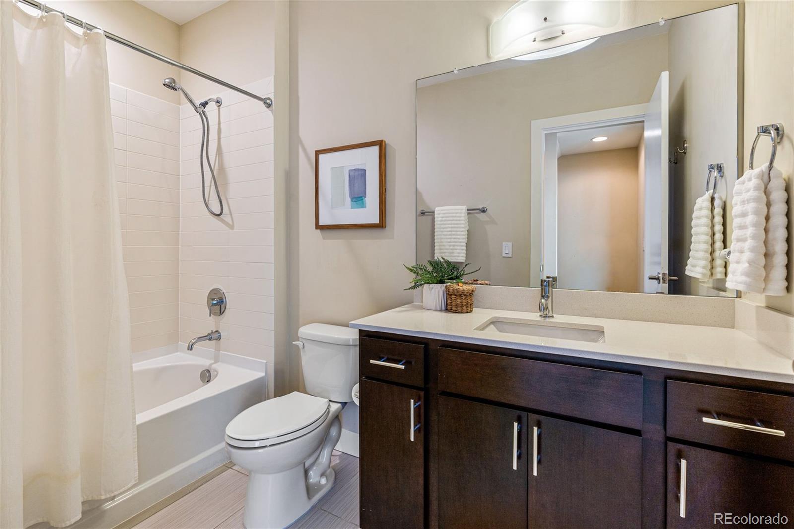 2146 Decatur Street Denver, CO 80211 - Photo 13 of 21 a bathroom with a double vanity sink toilet mirror and shower