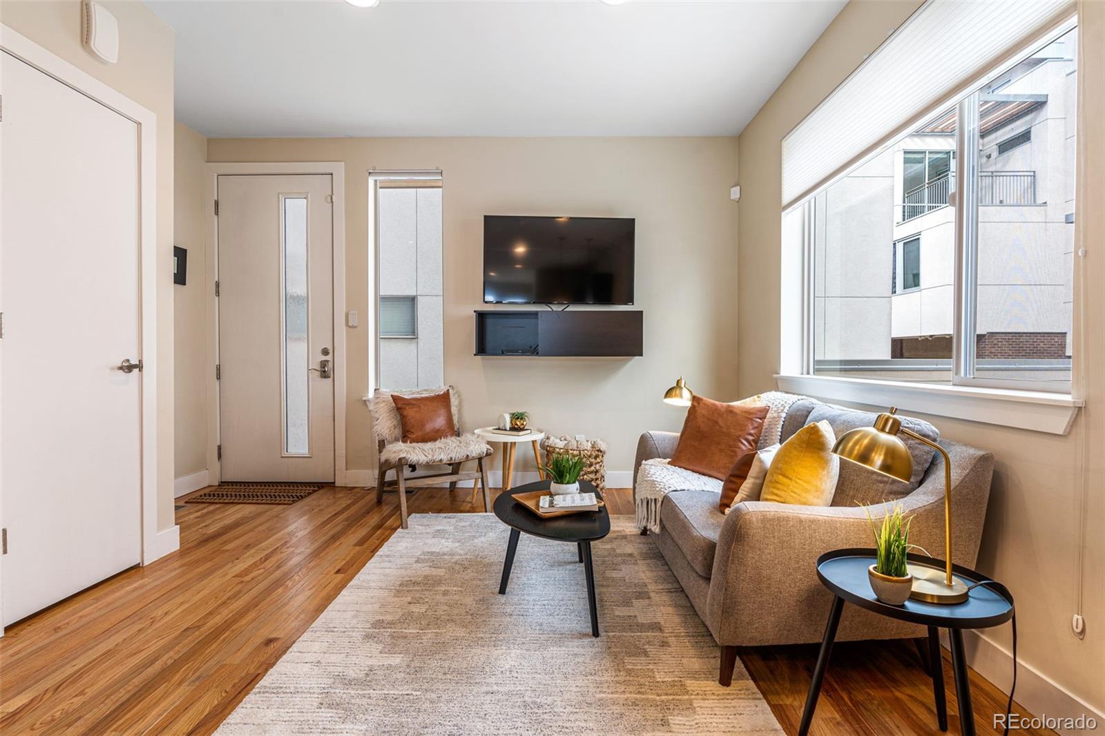 2146 Decatur Street Denver, CO 80211 - Photo 2 of 21 a living room with furniture and a flat screen tv