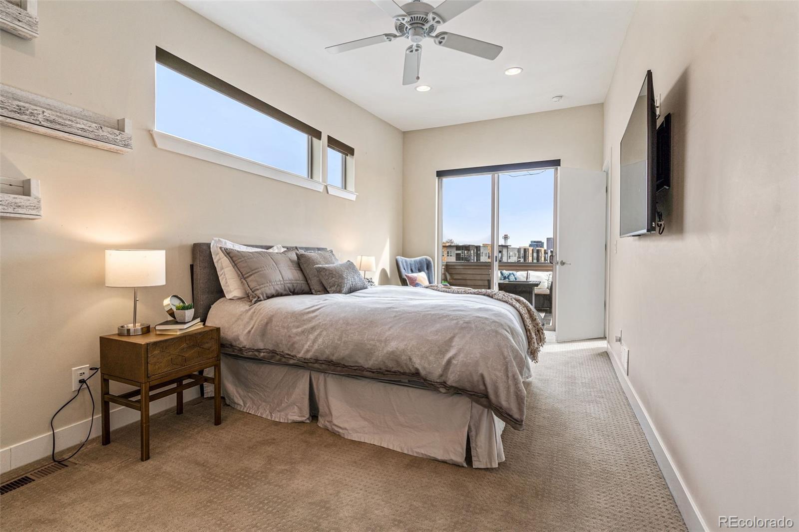 2146 Decatur Street Denver, CO 80211 - Photo 6 of 21 a spacious bedroom with a bed and a chandelier