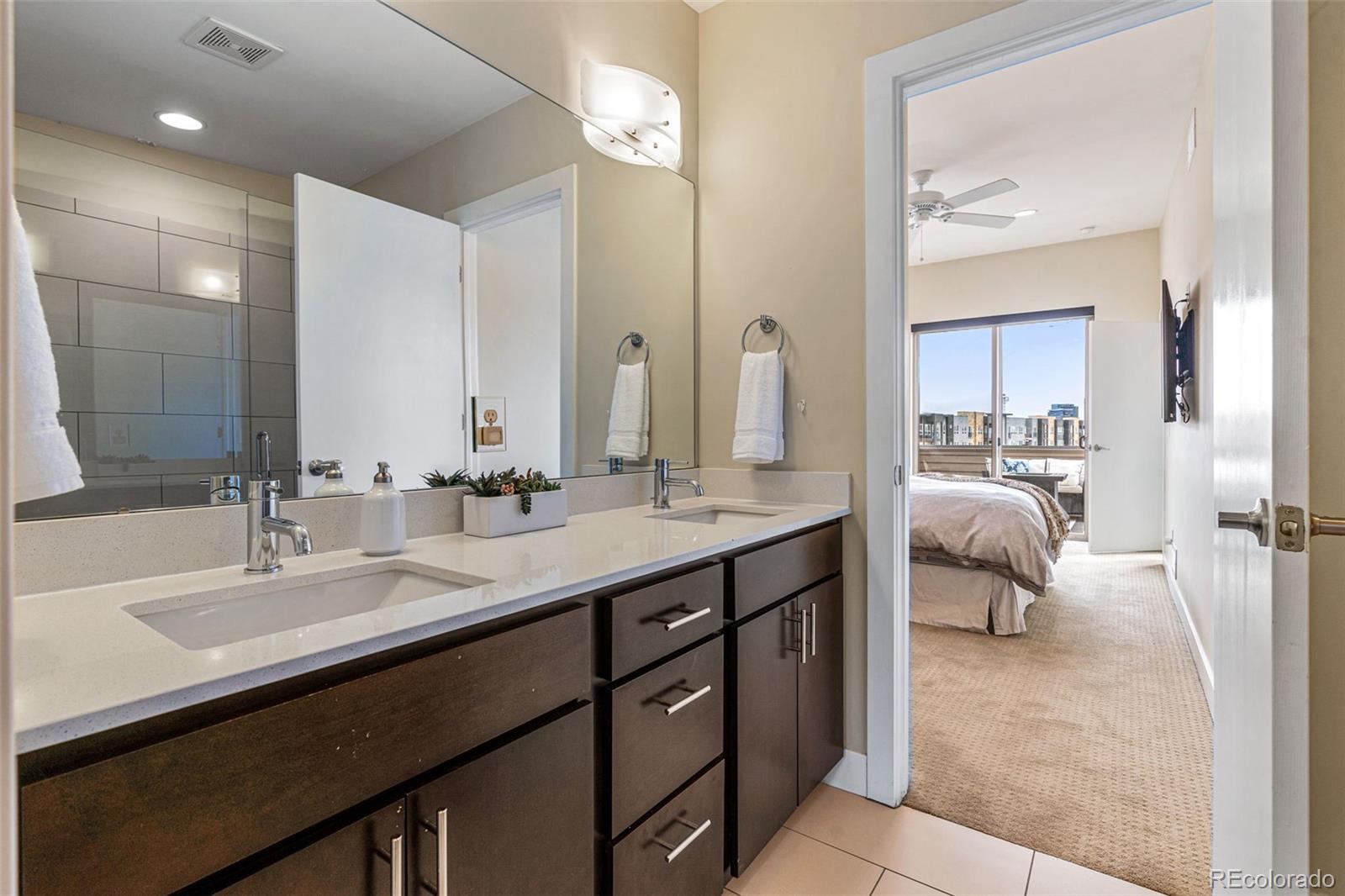 2146 Decatur Street Denver, CO 80211 - Photo 8 of 21 a en suite bathroom with double sink and a mirror