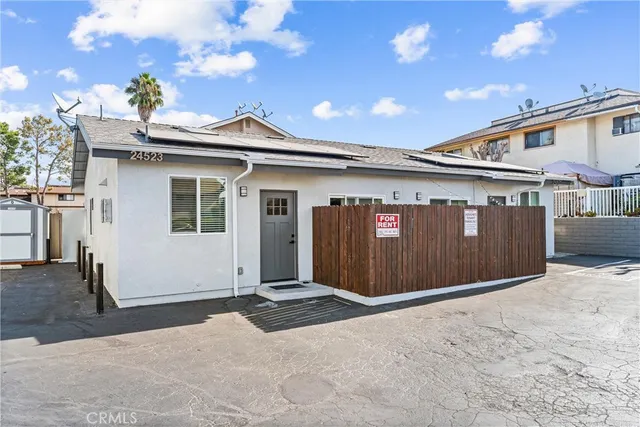 a aerial view of a house with large trees and city view