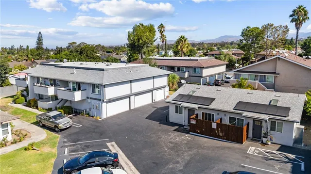 an aerial view of residential houses with outdoor space