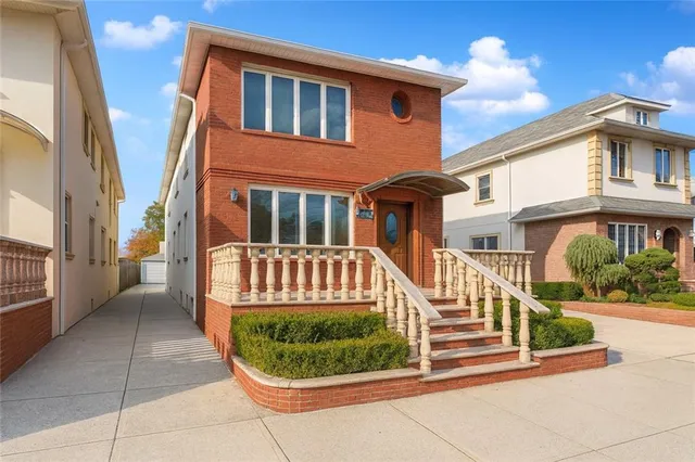 a view of a brick house with a yard