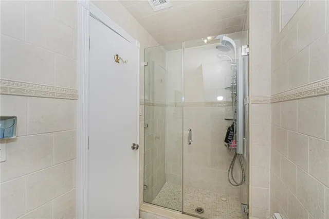 a bathroom with a glass shower door