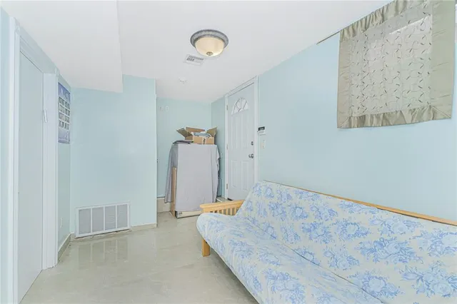 a bedroom with a bed and a painting on the wall