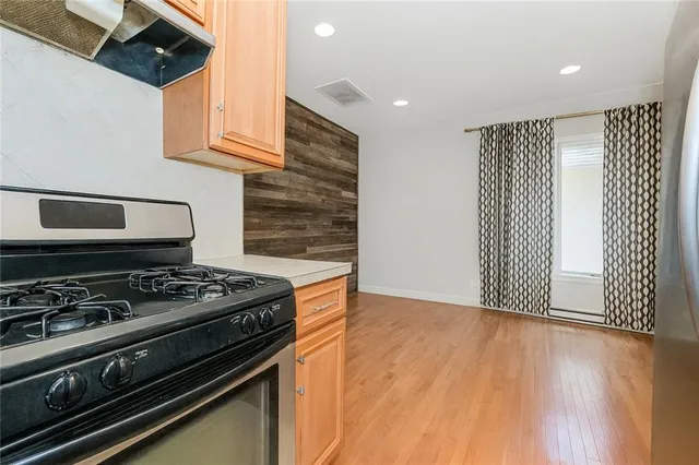 a stove top oven sitting inside of a kitchen
