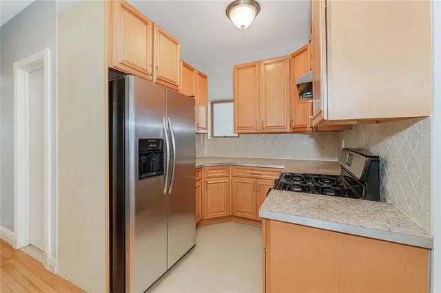 a kitchen with stainless steel appliances granite countertop a refrigerator and a stove