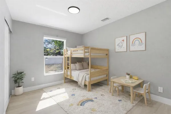 a bed room with a bed and a chair