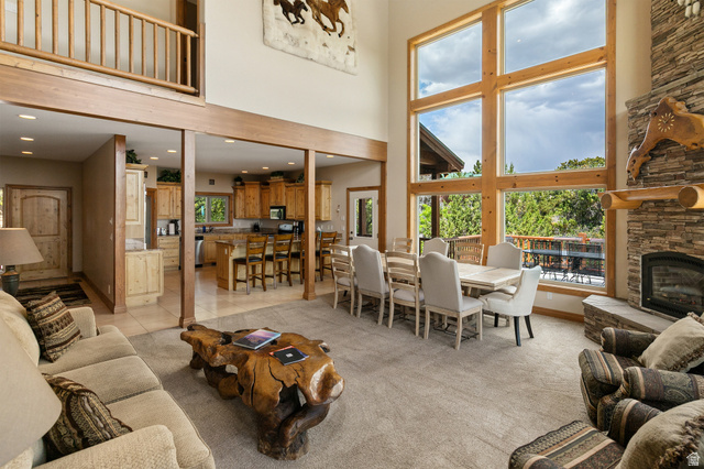 755 South Zion Ridge Drive Orderville, UT 84758 - Photo 47 of 84 Living room featuring light colored carpet, recessed lighting, a fireplace, a high ceiling, and light tile patterned flooring