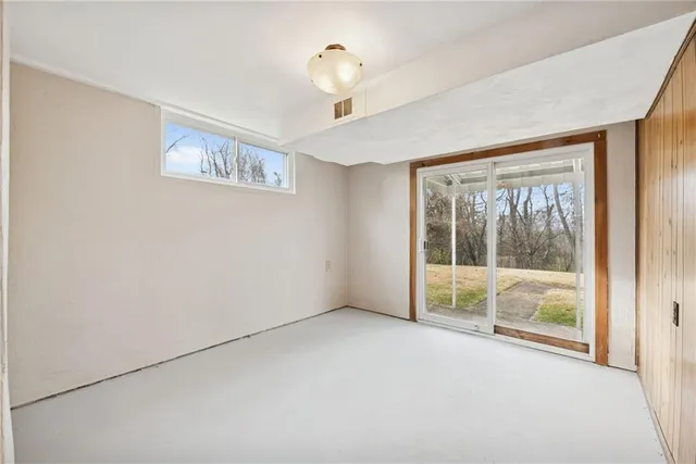a view of an empty room with glass door