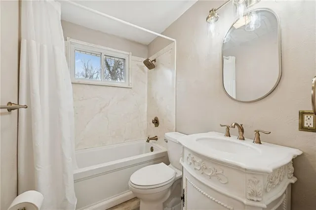 a bathroom with a sink toilet and a mirror