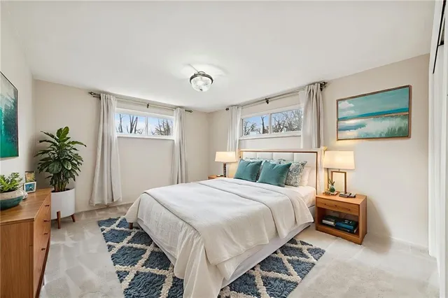 a bedroom with a bed and a potted plant