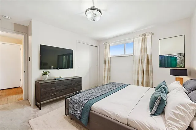 a bedroom with a bed and a flat screen tv