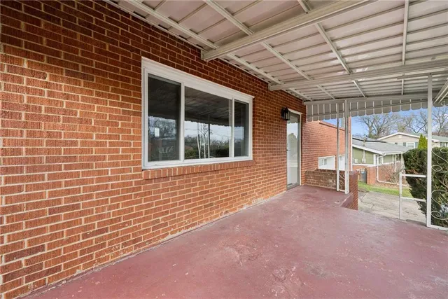 a view of an outdoor space with wooden roof and windows