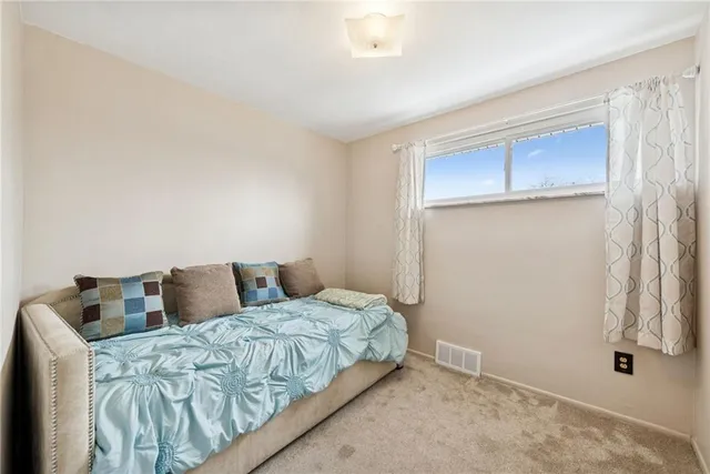 a bedroom with a bed and a mirror