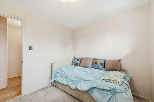 a bedroom with a bed and a night stand