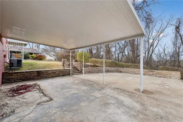 a view of an empty room with iron fence