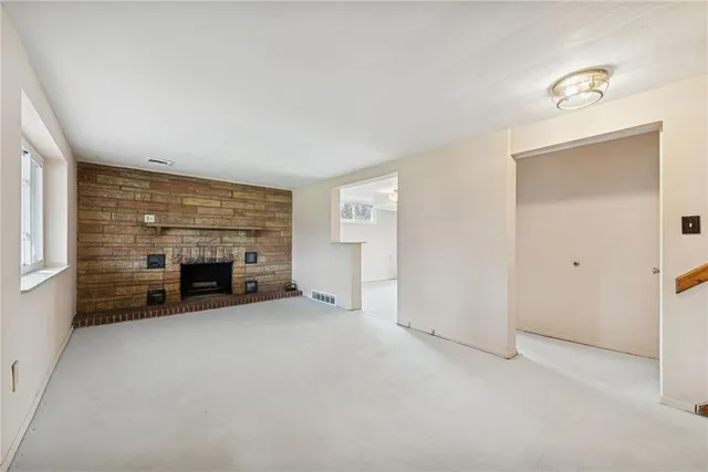 an empty room with furniture and a fireplace