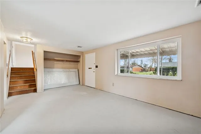 an empty room with cabinet and wooden floors