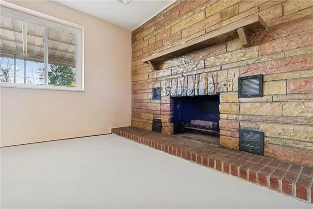 a view of an empty room with a fireplace