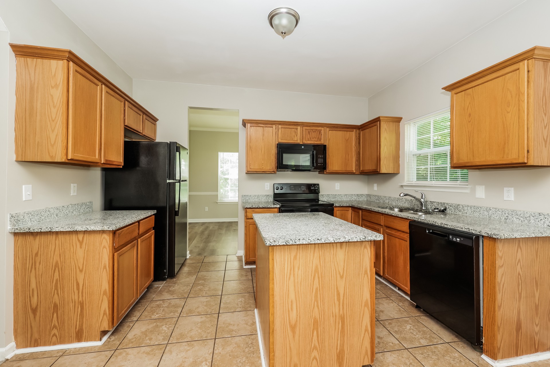 6104 Bentwood Drive Antioch, TN 37013 - Photo 2 of 17 a kitchen with granite countertop a sink and a stove top oven