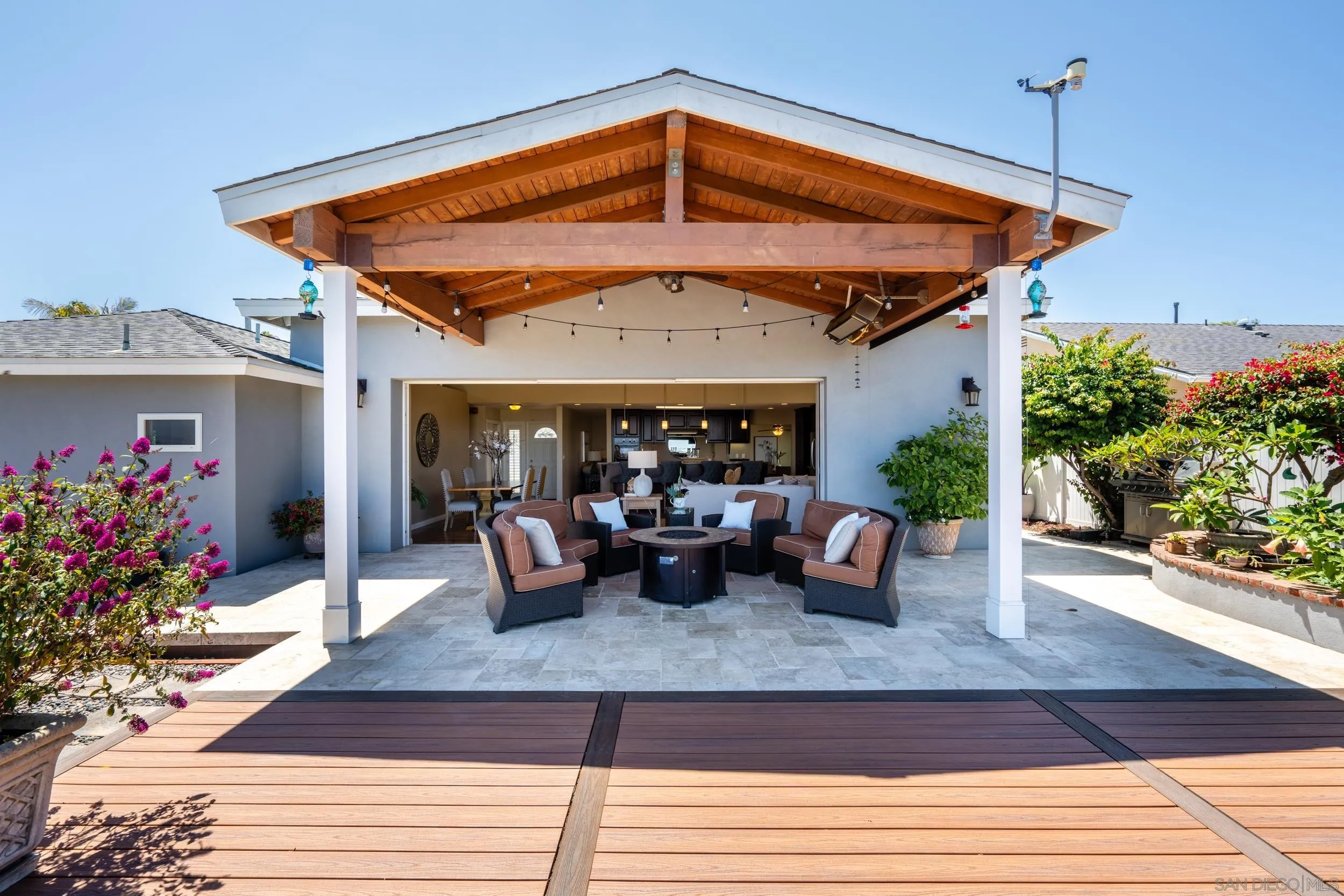 5785 Soledad Mountain Road La Jolla, CA 92037 - Photo 19 of 50 a view of a patio with a table and chairs potted plants