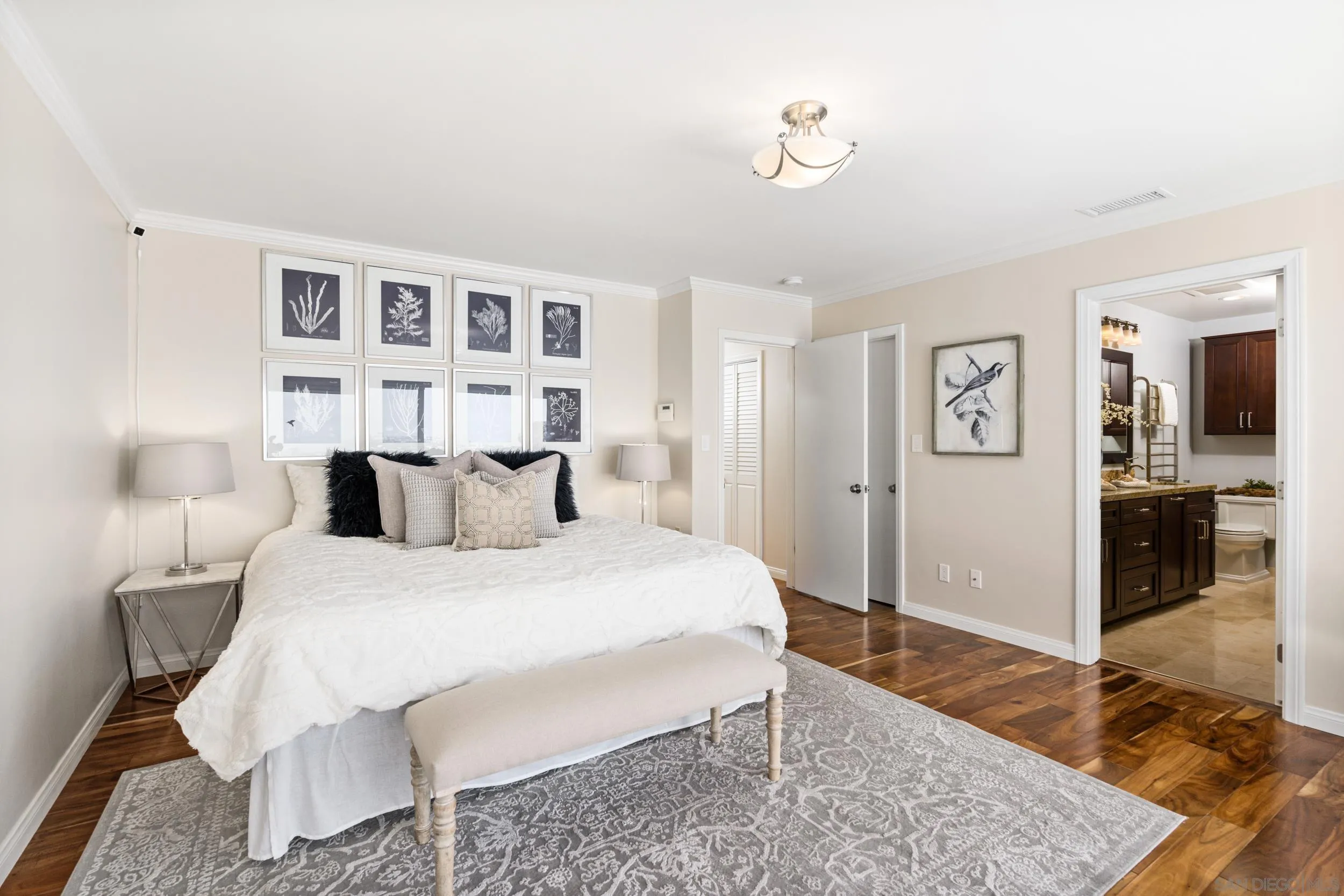 5785 Soledad Mountain Road La Jolla, CA 92037 - Photo 27 of 50 a bedroom with a bed and wooden floor