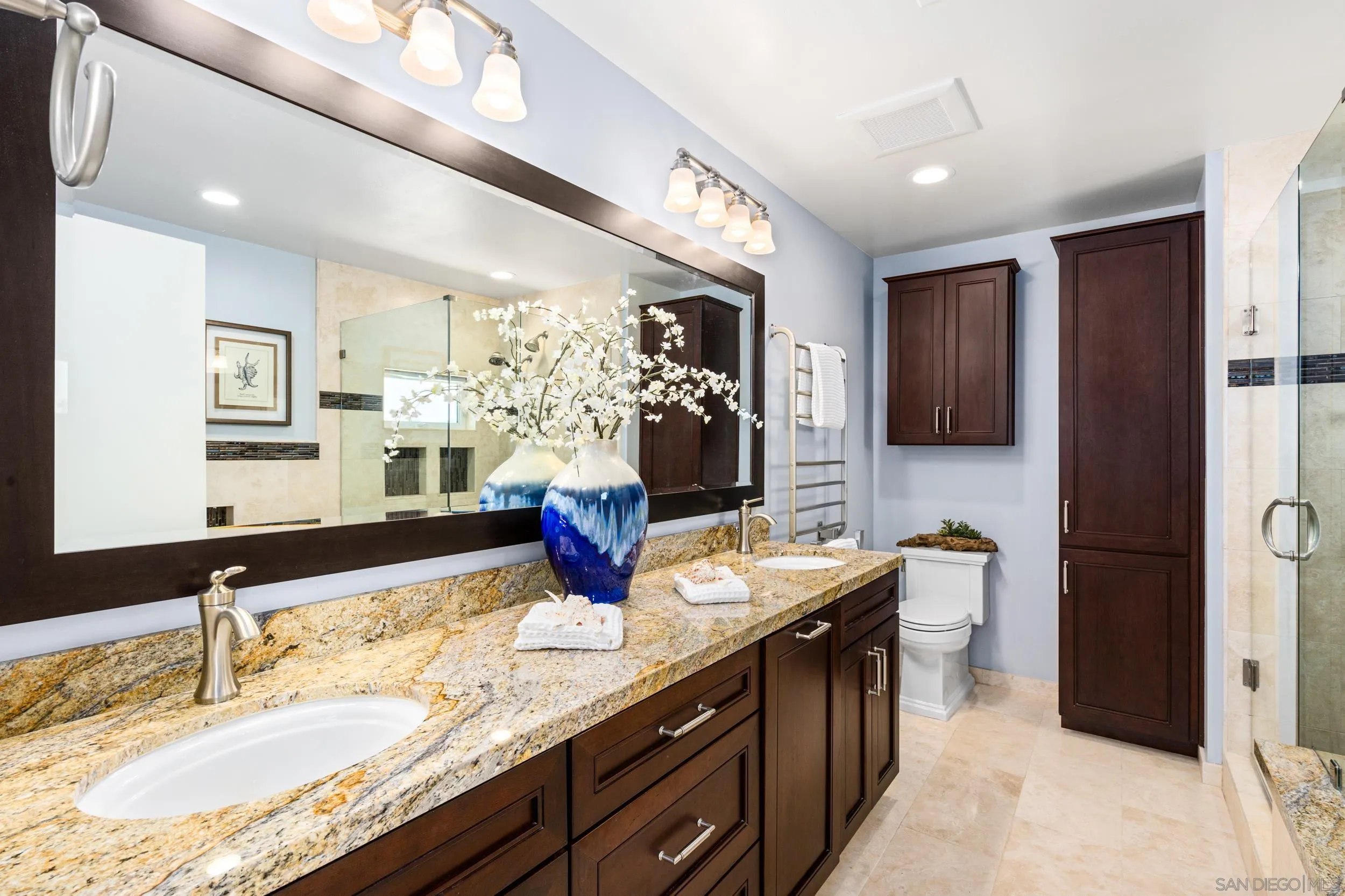 5785 Soledad Mountain Road La Jolla, CA 92037 - Photo 29 of 50 a bathroom with a granite countertop sink a large mirror and shower