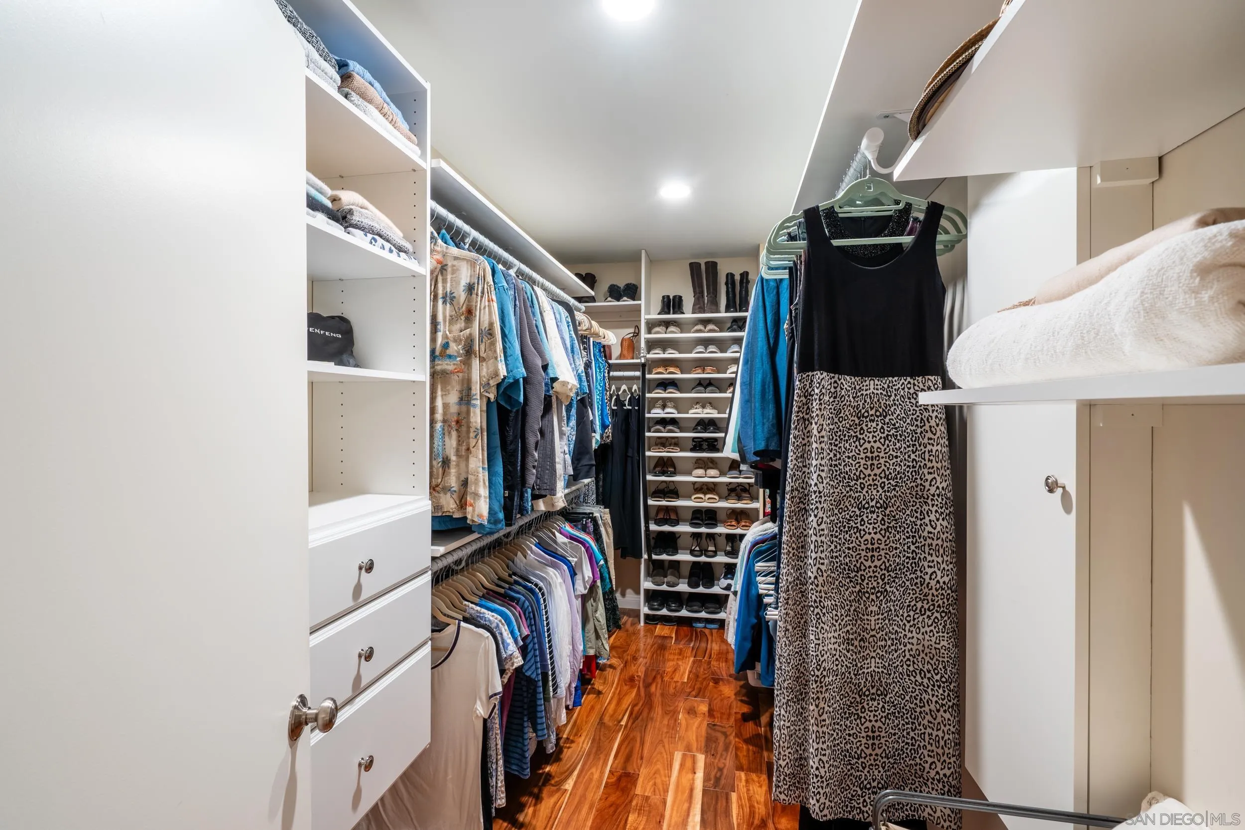5785 Soledad Mountain Road La Jolla, CA 92037 - Photo 34 of 50 a view of walk in closet with clothes and shoes
