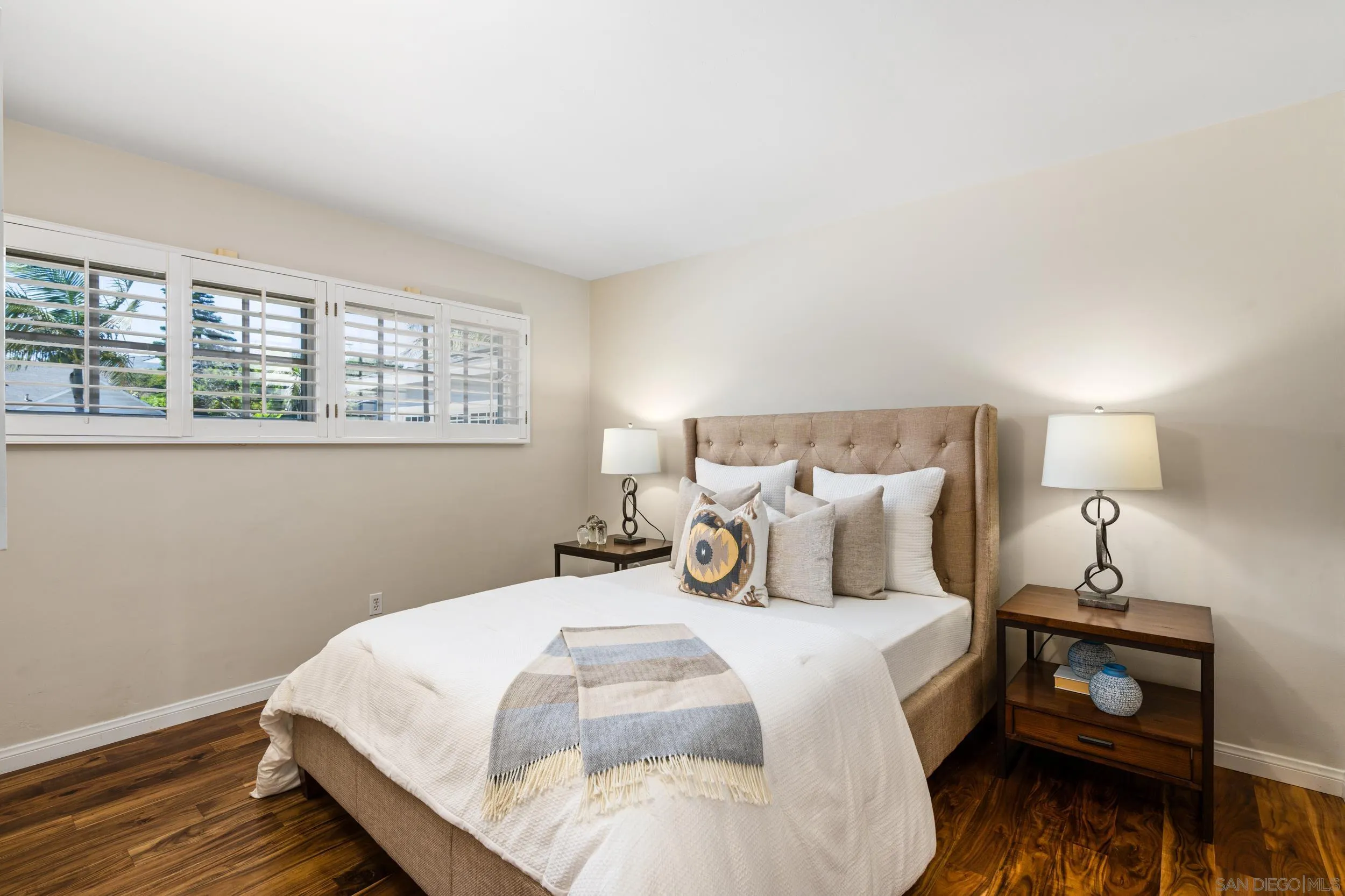 5785 Soledad Mountain Road La Jolla, CA 92037 - Photo 36 of 50 a bedroom with a bed and wooden floor