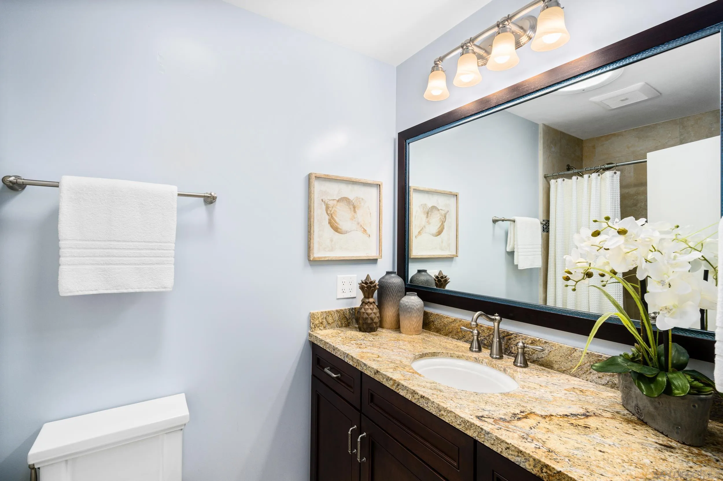 5785 Soledad Mountain Road La Jolla, CA 92037 - Photo 37 of 50 a bathroom with a granite countertop sink and a mirror