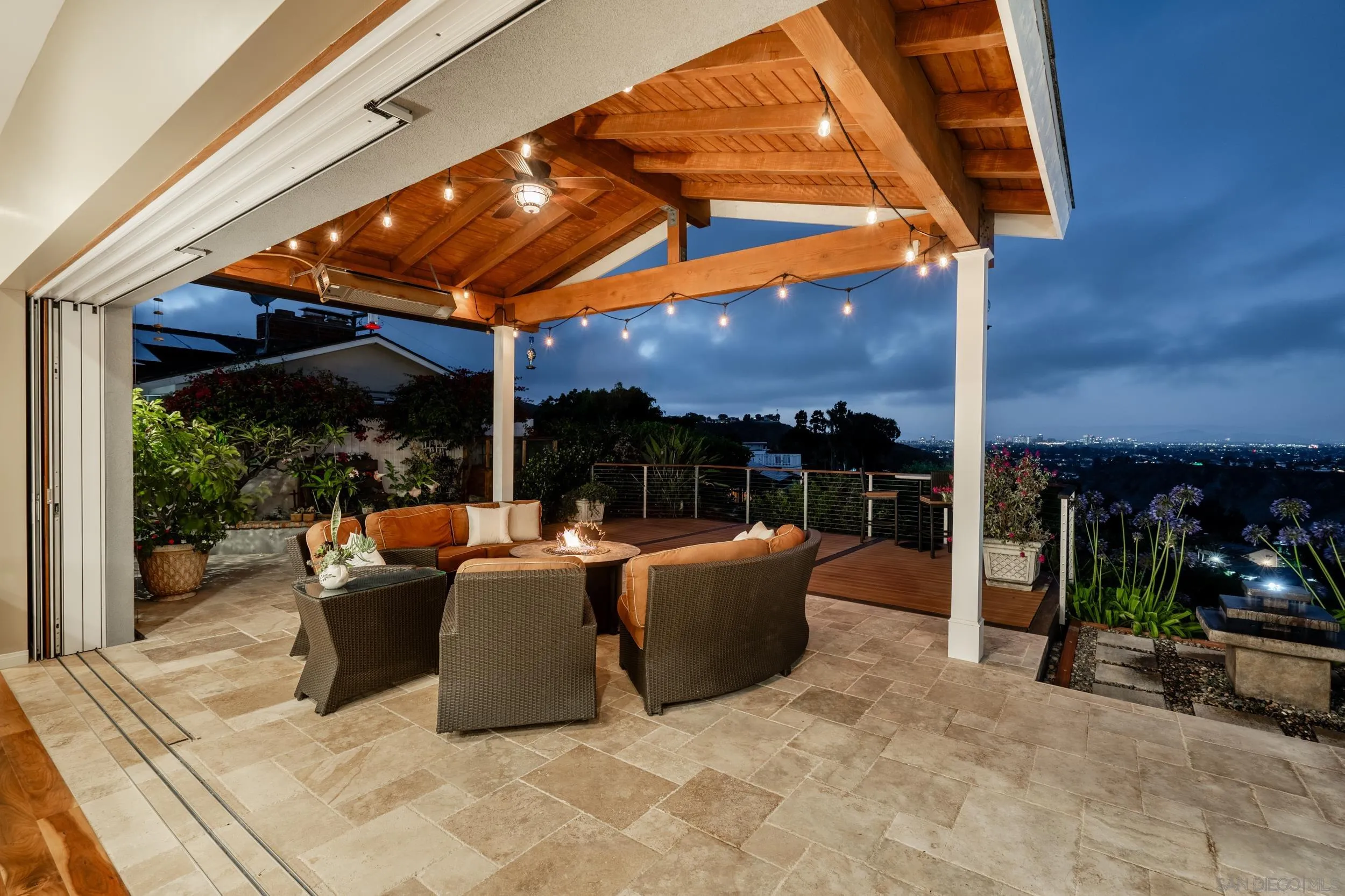 5785 Soledad Mountain Road La Jolla, CA 92037 - Photo 40 of 50 a view of a patio with a table and chairs under an umbrella