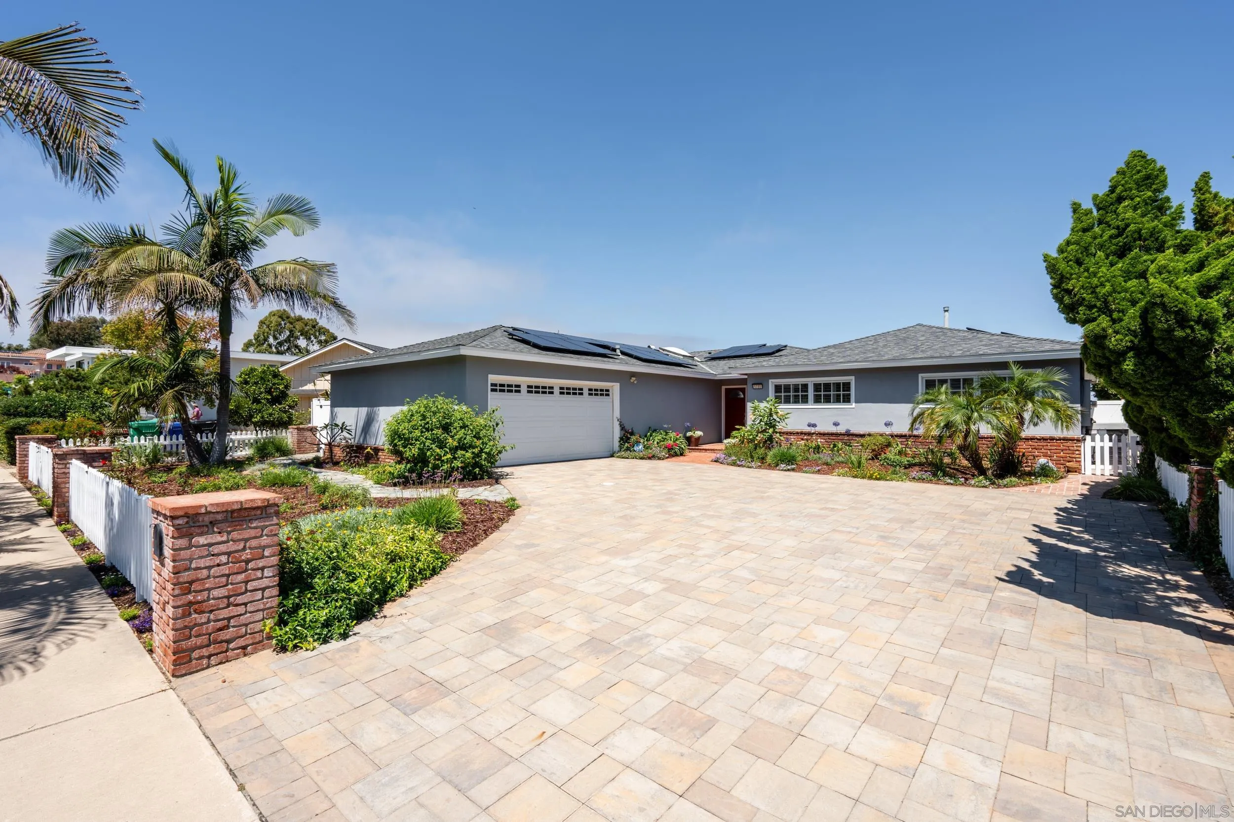 5785 Soledad Mountain Road La Jolla, CA 92037 - Photo 6 of 50 a front view of a house with a yard and a garage