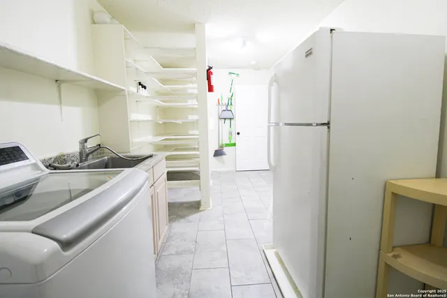 a kitchen with a refrigerator and a sink