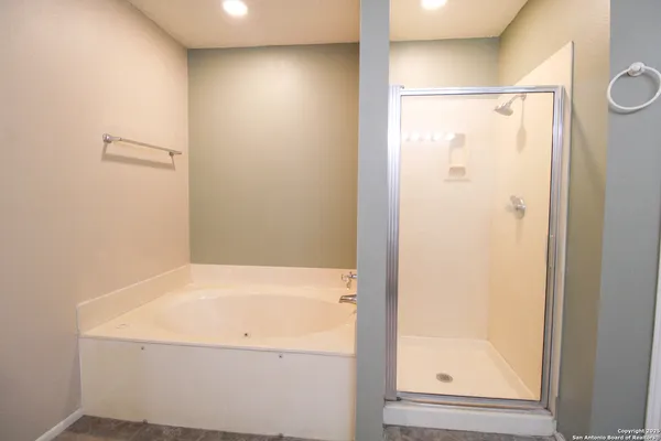 a bathroom with a bathtub and a shower