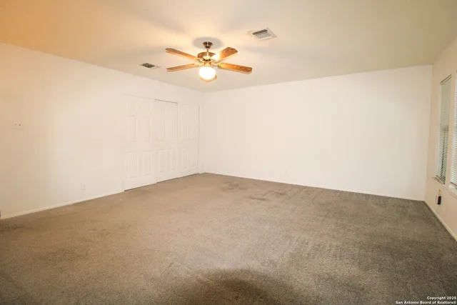a bathroom with a granite countertop sink a toilet and bathtub