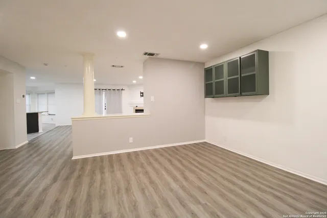 a view of kitchen with kitchen island wooden floor and window