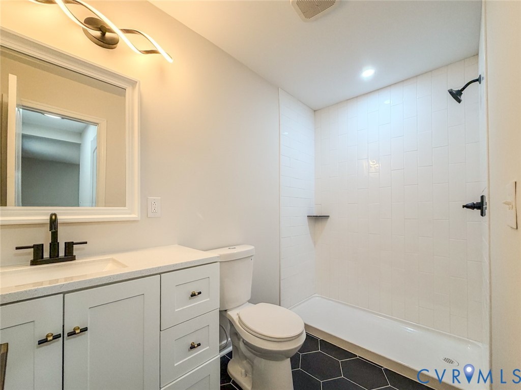 3409 Meadowbridge Road Richmond, VA 23222 - Photo 17 of 32 a bathroom with a sink toilet vanity and shower