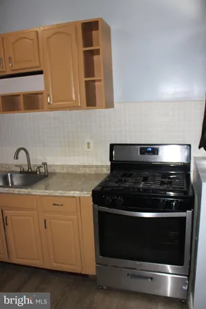 a stove top oven sitting inside of a kitchen