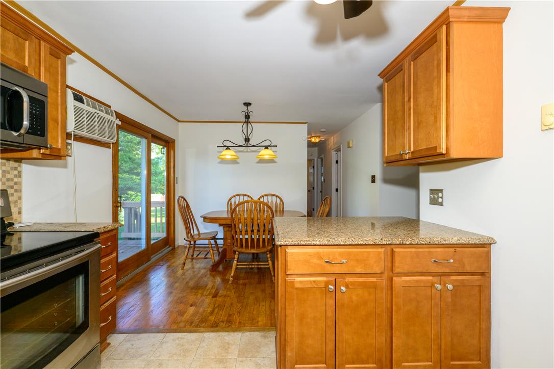 1644 9th Street Bethlehem, PA 18020 - Photo 6 of 27 Granite counters and rich wood cabinetry define this inviting kitchen and dining space.