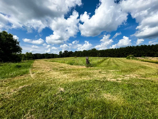 a kitchen with stainless steel appliances kitchen island granite countertop a table chairs sink and cabinets