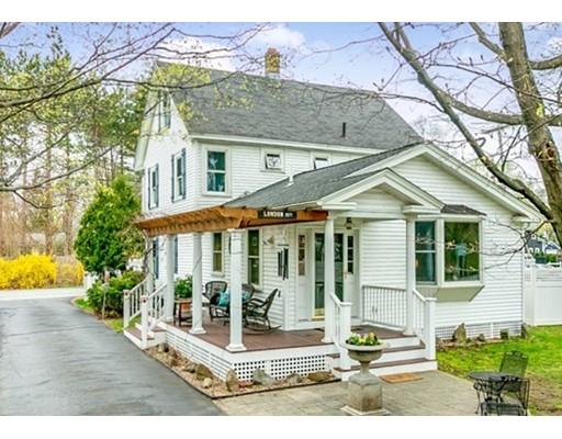 267 North Road Sudbury, MA 01776 - Photo 1 of 23 a view of a white house with large windows and a table and chairs