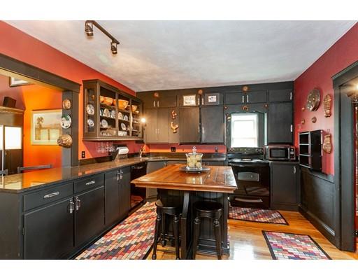 267 North Road Sudbury, MA 01776 - Photo 10 of 23 a kitchen with stainless steel appliances kitchen island granite countertop dining table chairs cabinets and a sink