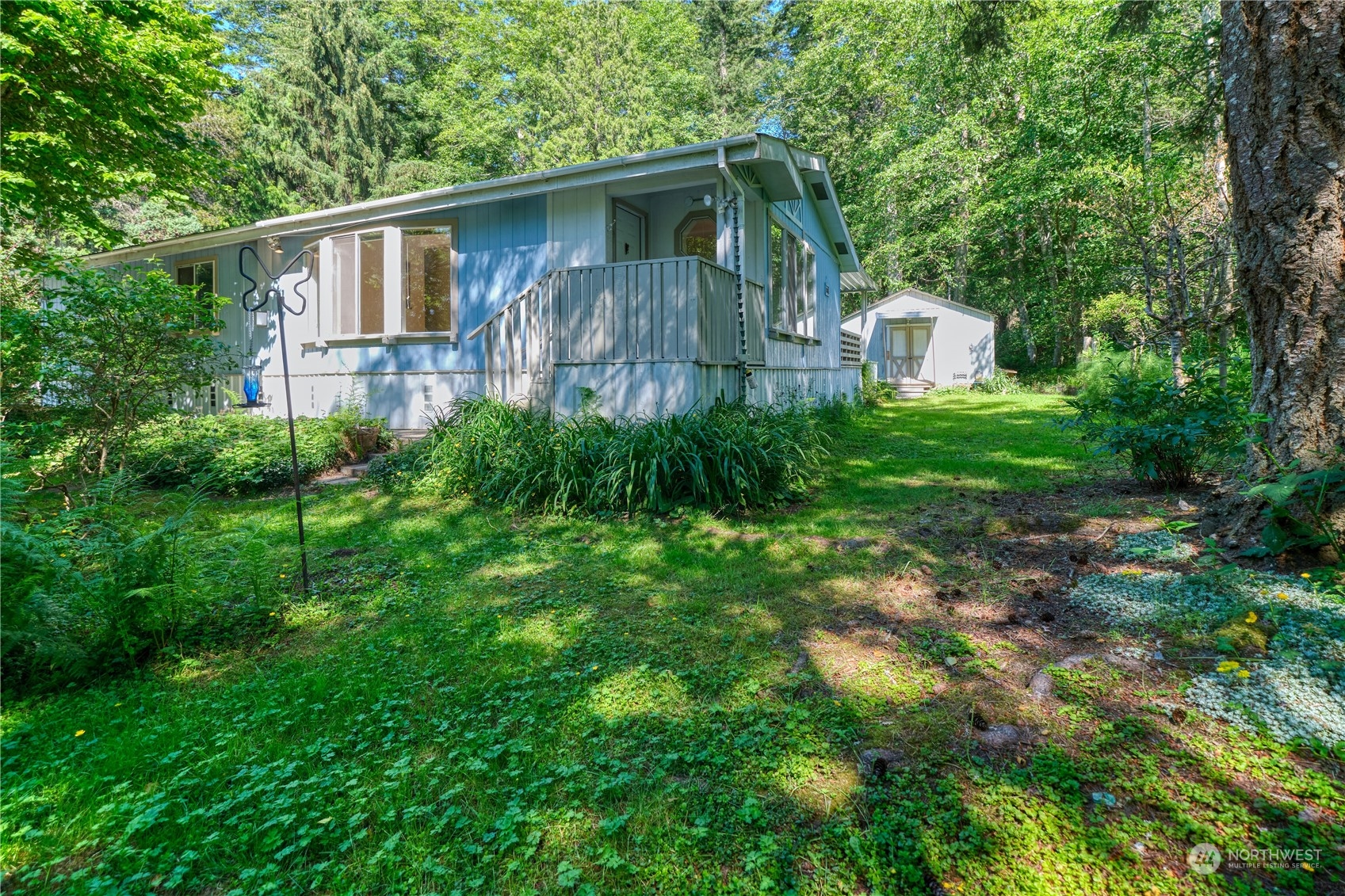 1721 Benson Road, Unit 119 Point Roberts, WA 98281 - Photo 1 of 24 a front view of house with yard and trees