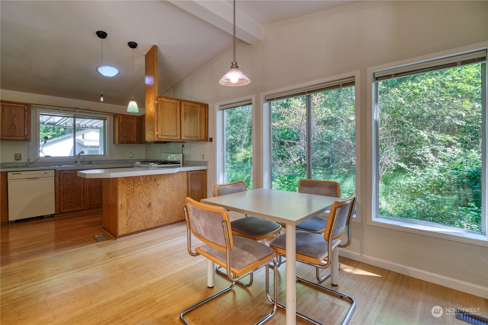 1721 Benson Road, Unit 119 Point Roberts, WA 98281 - Photo 5 of 24 a view of a dining room with furniture window and wooden floor