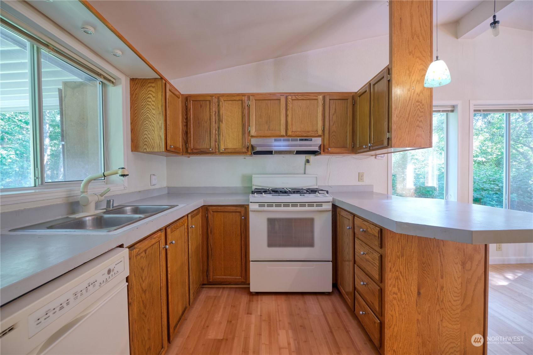 1721 Benson Road, Unit 119 Point Roberts, WA 98281 - Photo 6 of 24 a kitchen with a sink stove and cabinets
